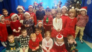 zdjęcie grupowe dzieci na tle świątecznej dekoracji.